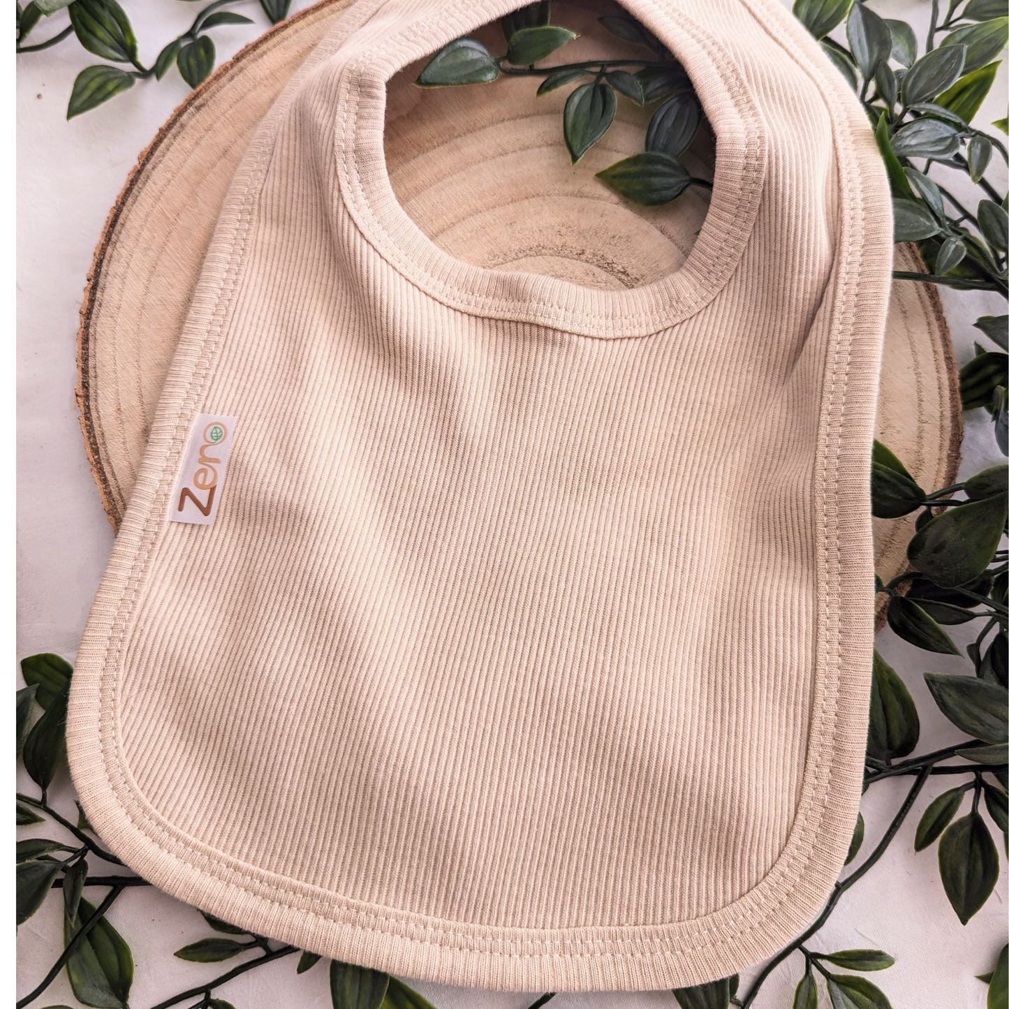 Unisex Baby Clothes - Baby bib in biscuit colour, ribbed design. Perfect unisex newborn clothing accessory. (Featured on a neutral background)