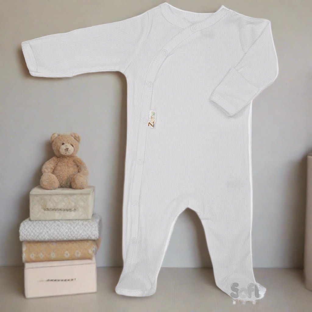 Unisex newborn clothes - Baby sleepsuit in white, made from eco friendly materials featuring a ribbed textured design. (Featured with a nursery background)