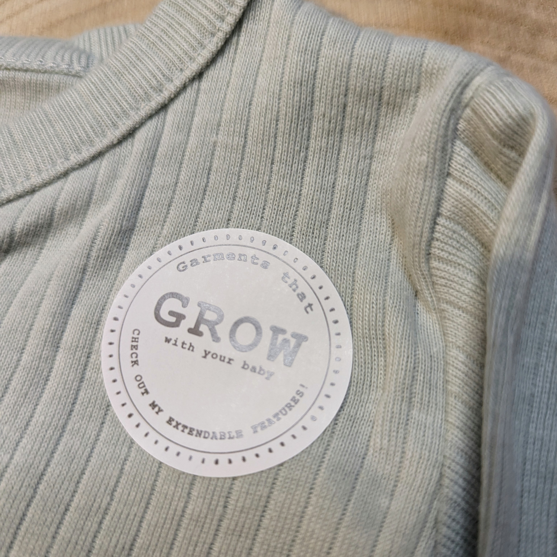 Sage unisex organic cotton baby clothes set with bodysuit, trousers, and bear hat. Designed for comfort, growth, and sustainability by Homegrown Baby.